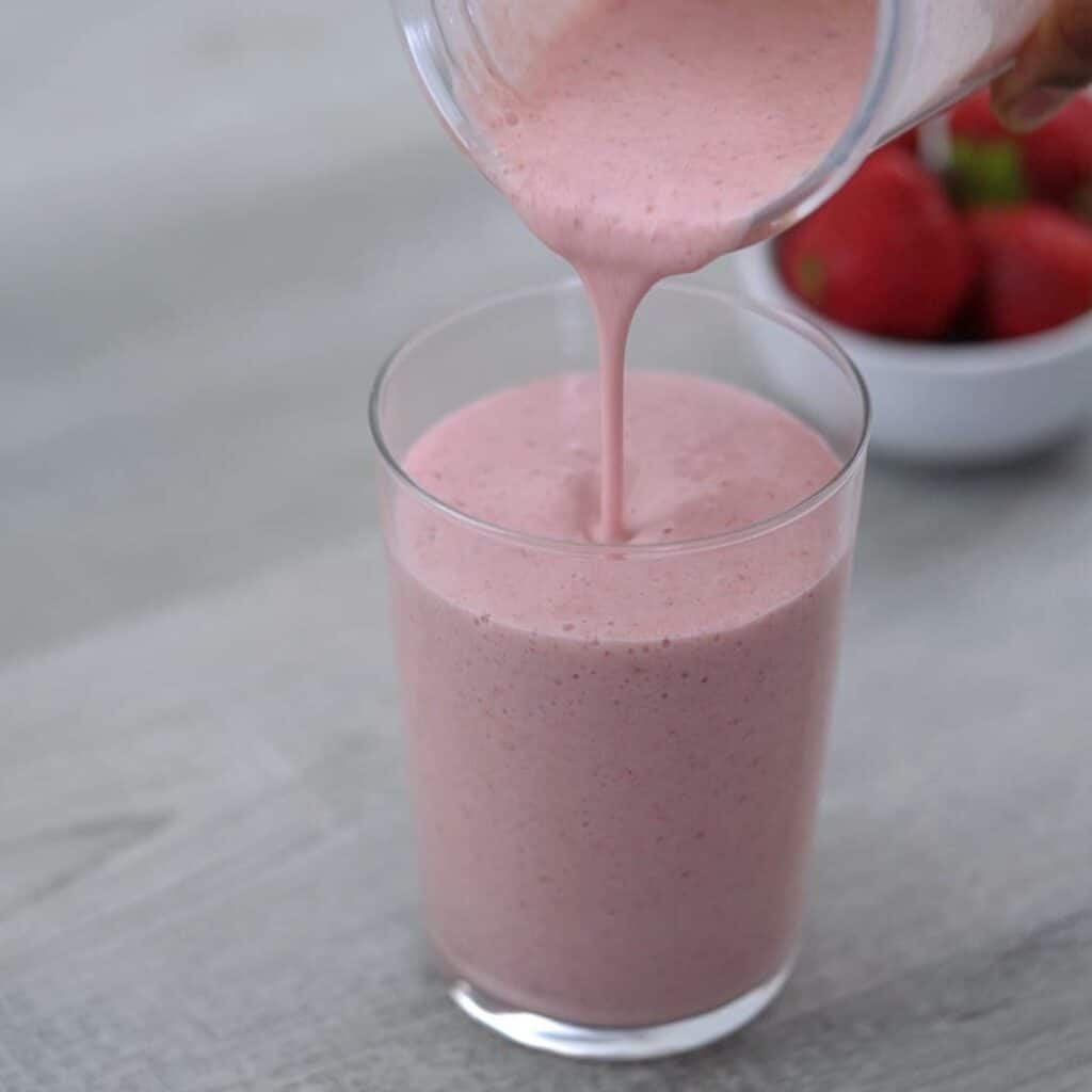 Pouring the Strawberry Banana Smoothie over a glass