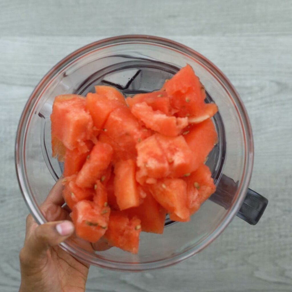 adding water melon to the blender