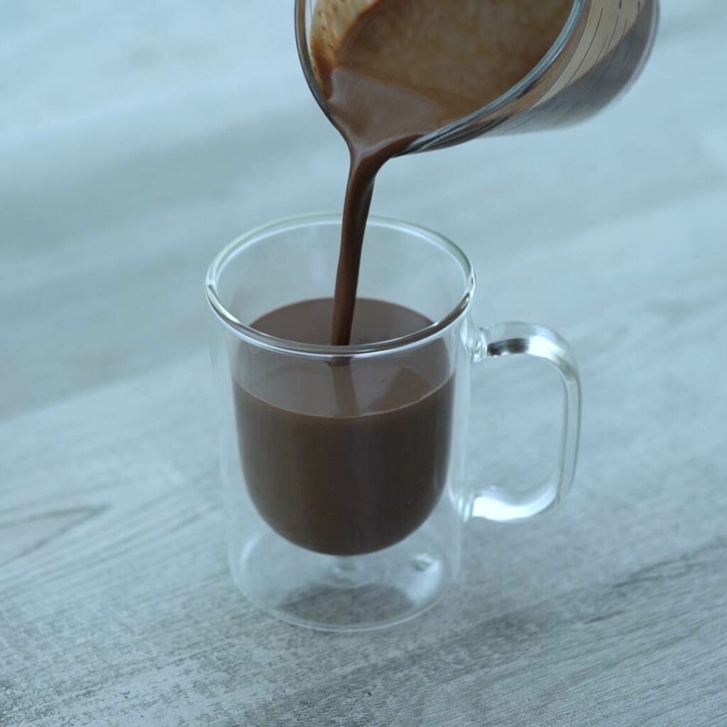 Pouring hot chocolate to serving glass