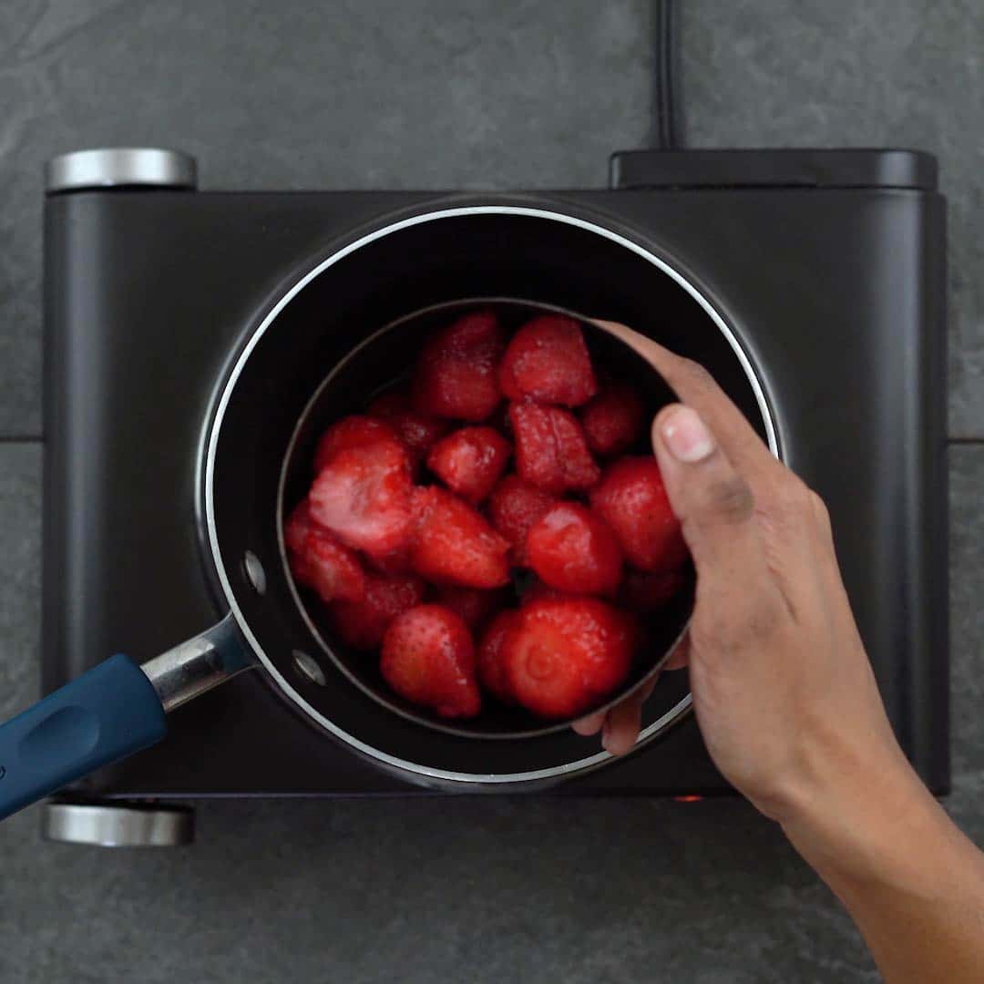 Adding strawberries to pan