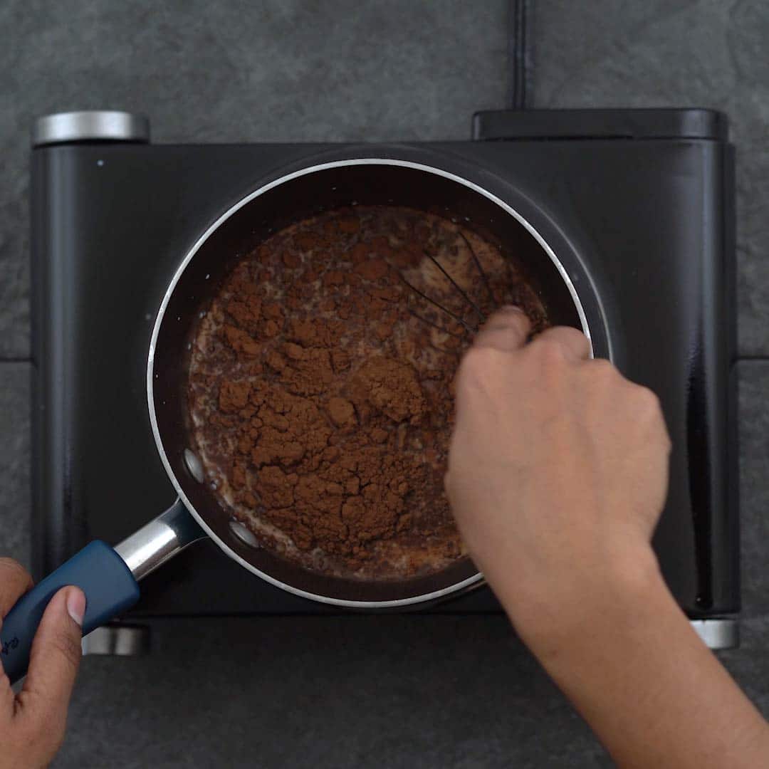 Mixing chocolate chips and cocoa powder to milk