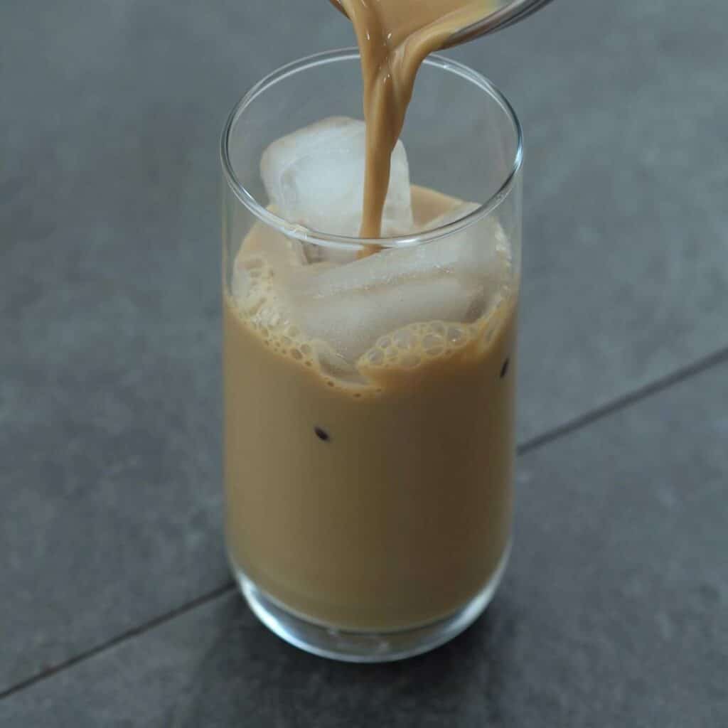 pouring Vietnamese Coffee over ice cubes