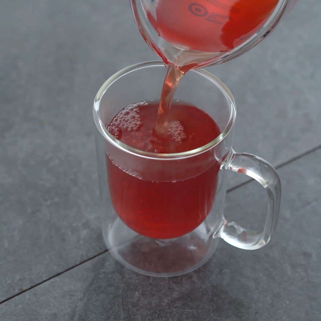 pouring ginger tea to serving glass