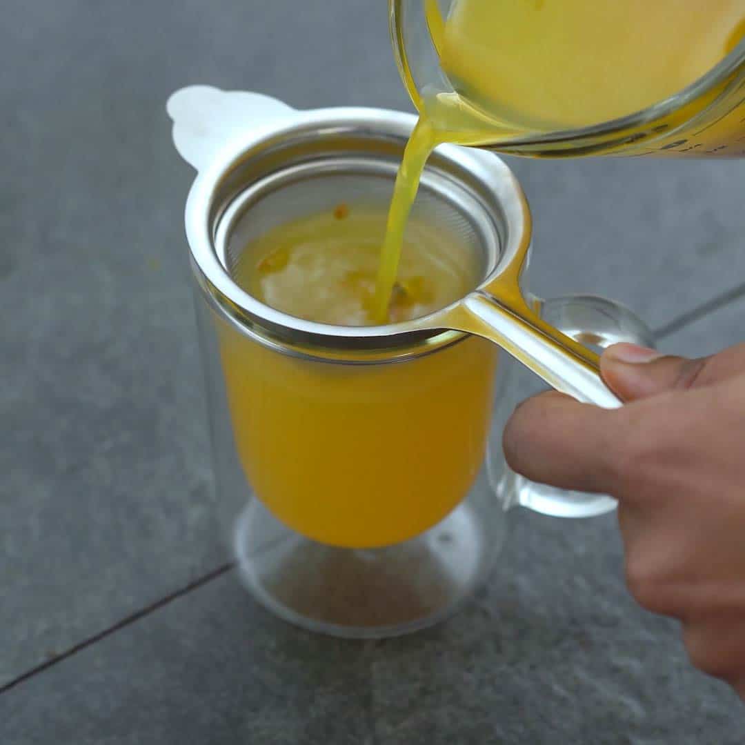 Filtering the Turmeric Tea into serving glass