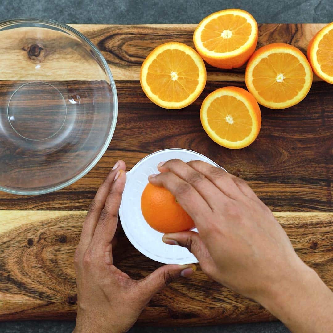 squeezing the oranges to extract juice