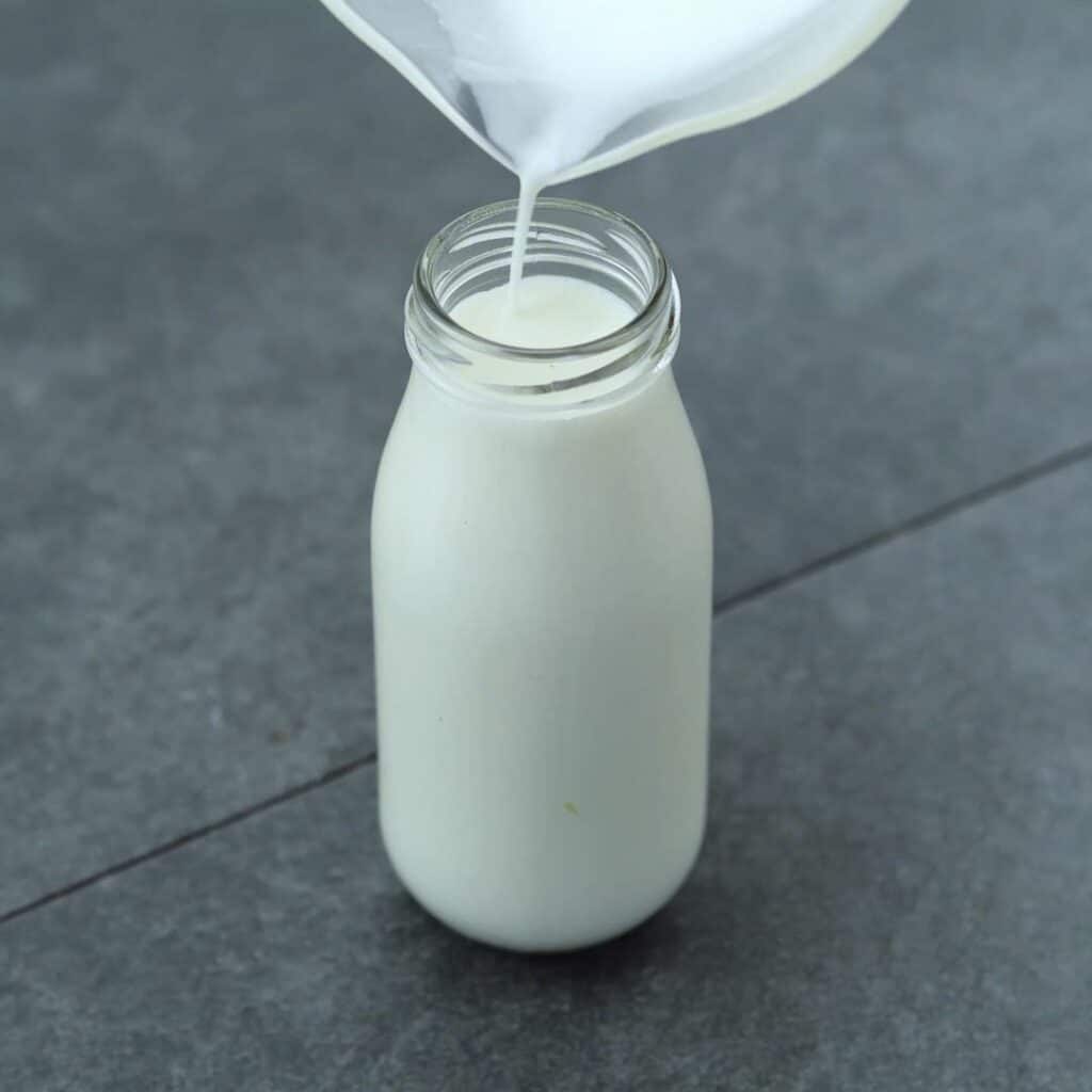 Pouring Buttermilk Substitute into the glass