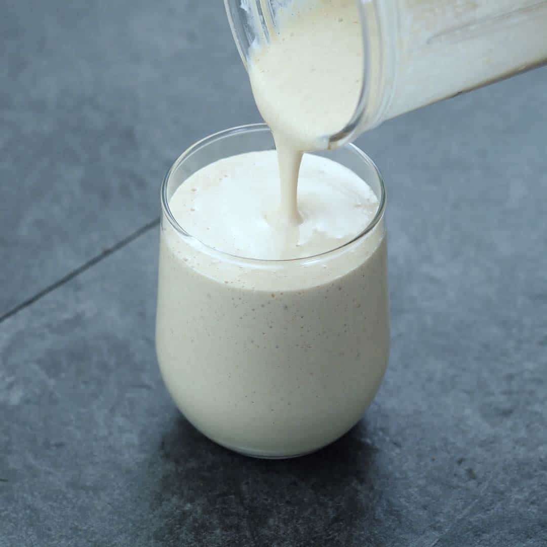 Pouring Oatmeal Smoothie into a serving glass
