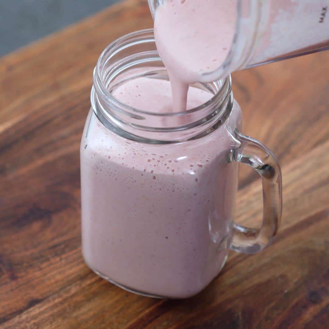 Pouring Greek Yogurt Smoothie into a serving glass