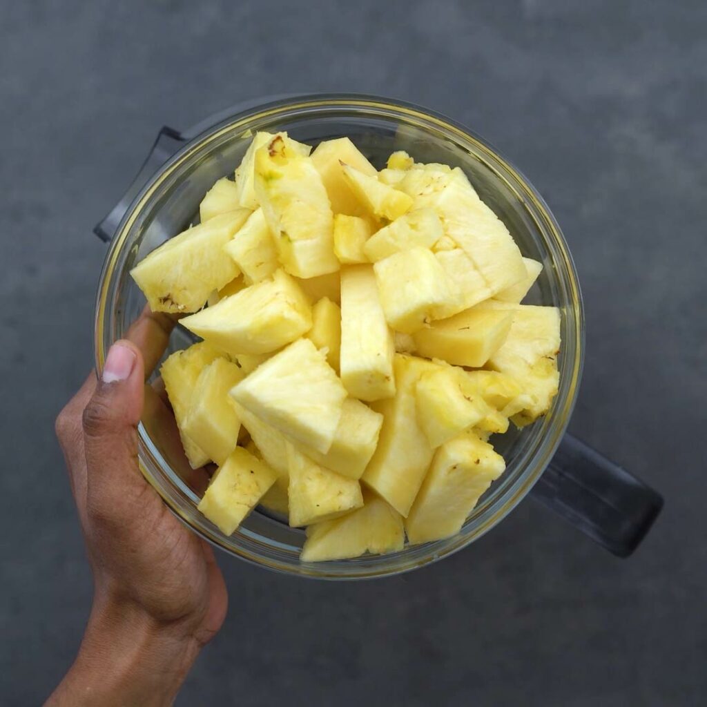 Adding chopped pineapple into jar