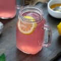 Pink Lemonade in a serving mug. Honey and lemon placed nearby