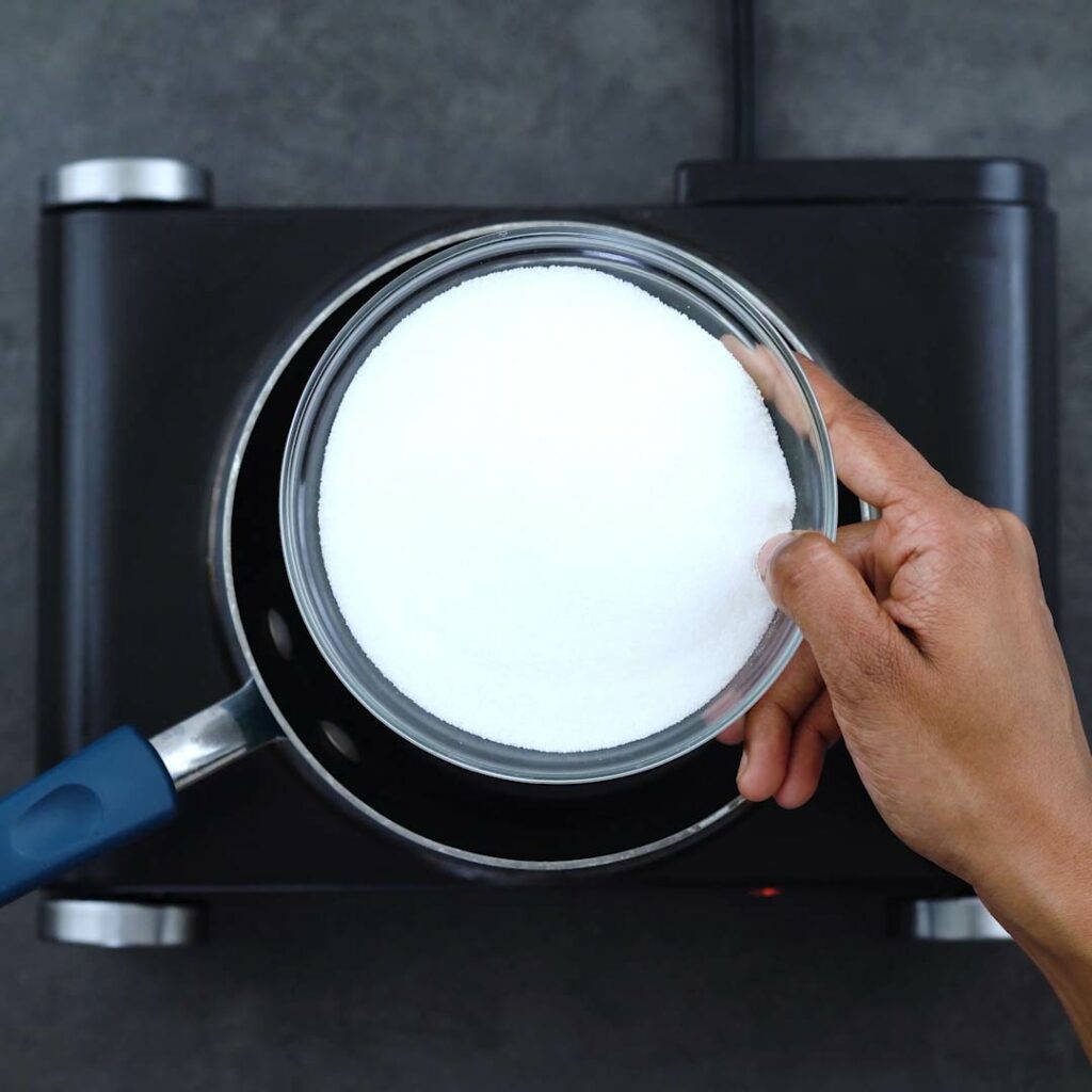 Adding sugar into a saucepan