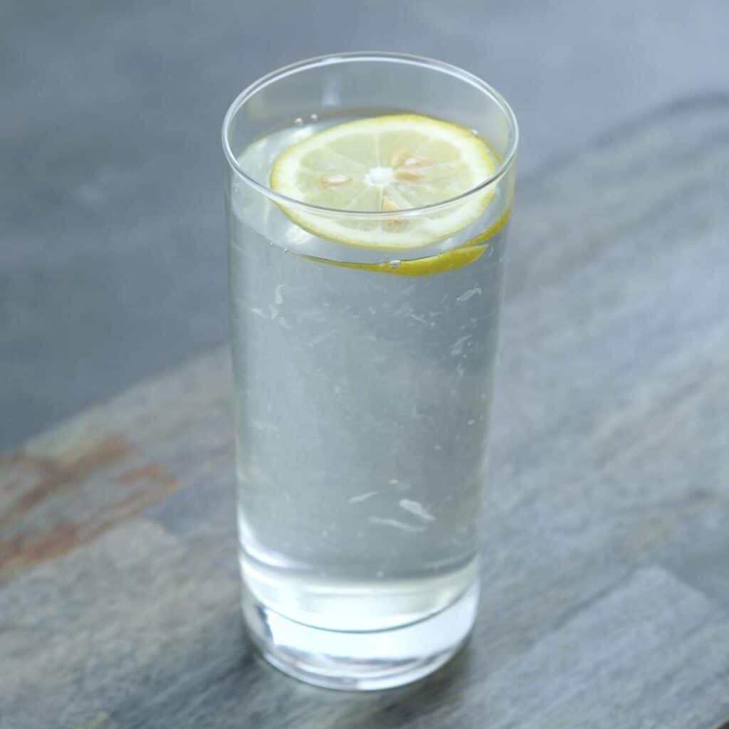 Lemon Water in a serving glass with lemon slice